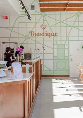 The modern and inviting interior of a Toastique café.