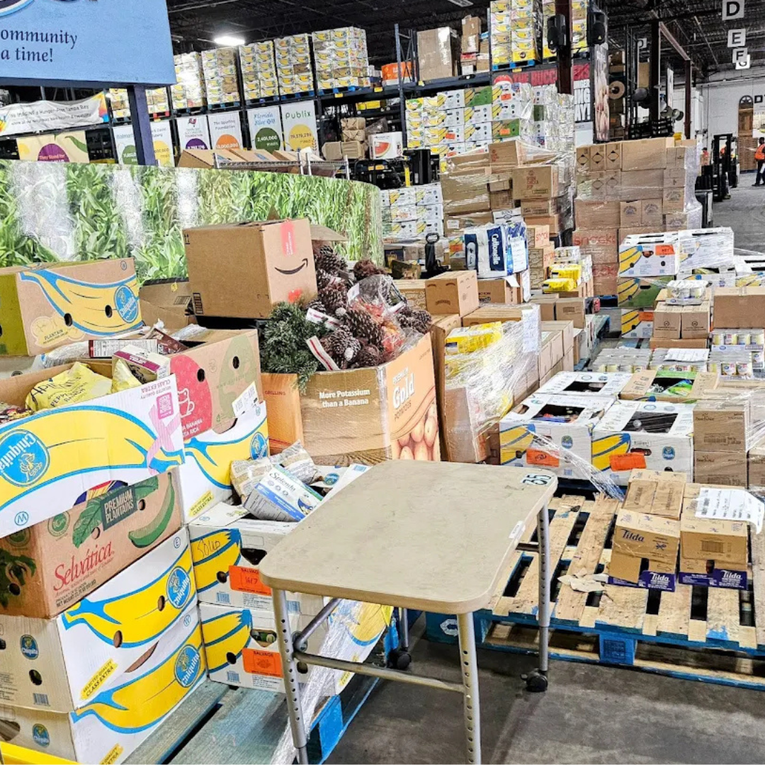 Boxes of donated goods at a community event, representing CAKE's commitment to serving beyond the table.