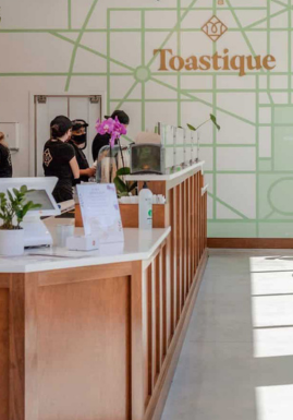 The front counter of a Toastique café with the CAKE POS system installed.