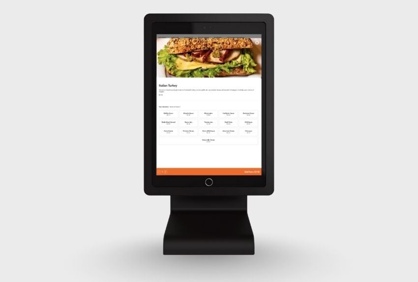 The CAKE Self-Ordering Kiosk, showing a customer-facing screen with a sample order.